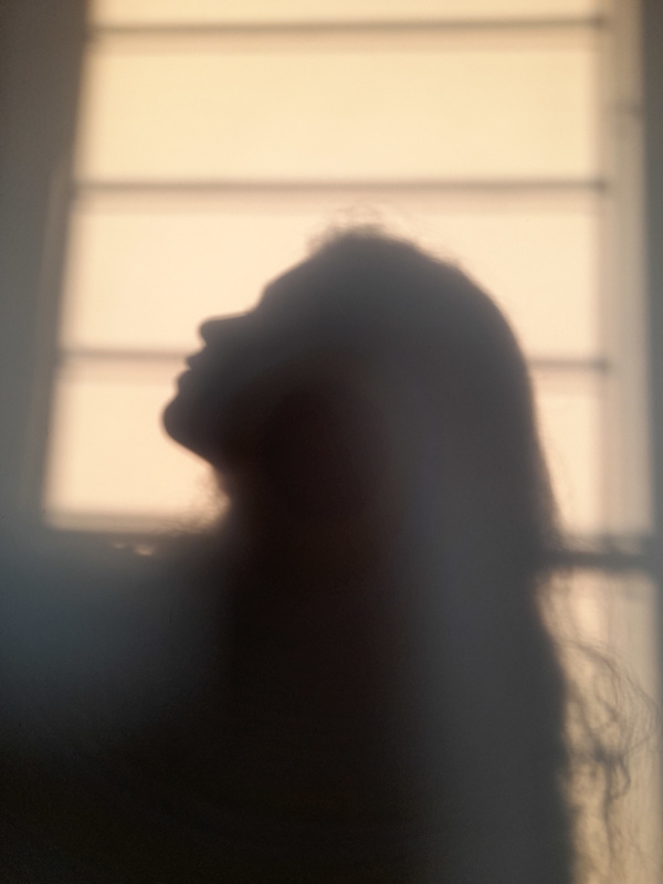 Shadow of Woman on House Wall